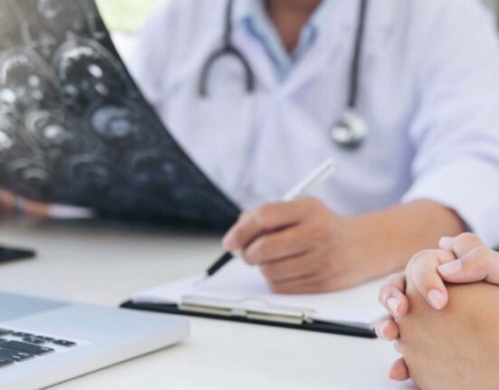 Doctor with patient explaining stages of cancer