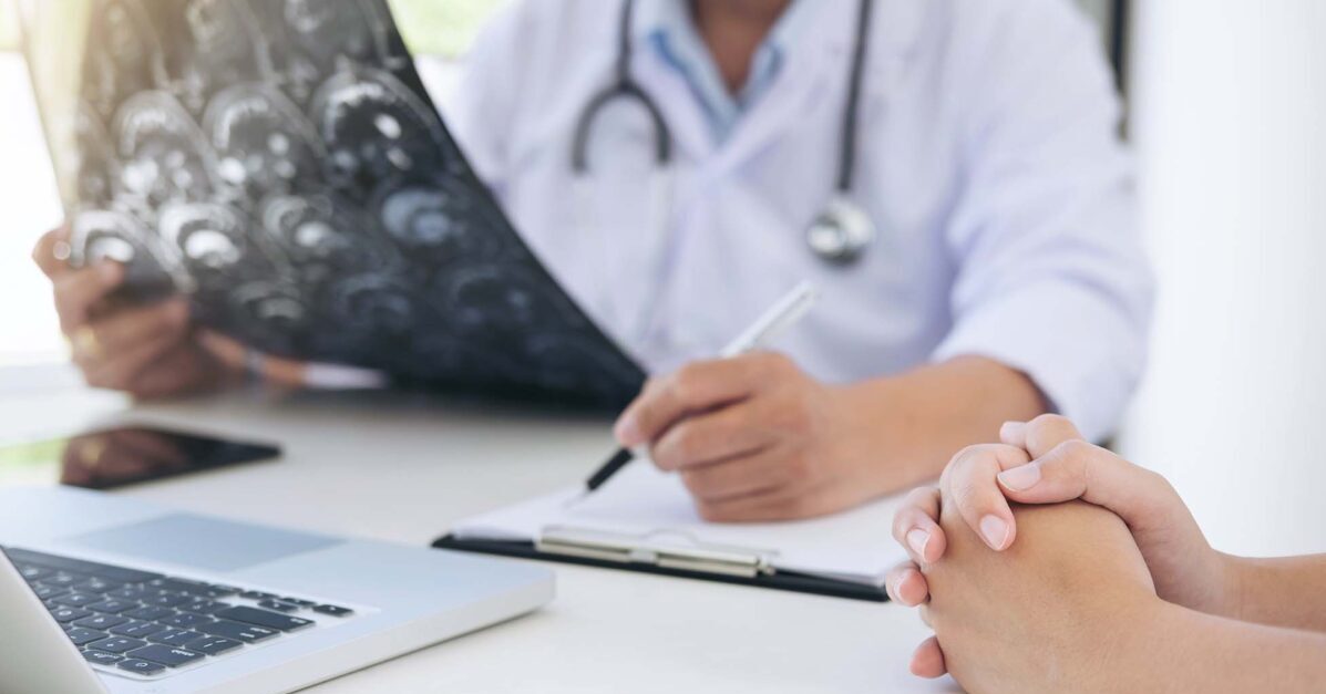 Doctor with patient explaining stages of cancer