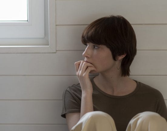 medium-shot-young-woman-sitting-floor