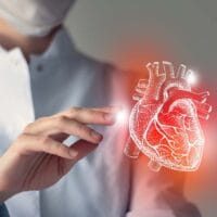 Female doctor touchstone virtual Heart in hand. Blurred photo, handrawn human organ, highlighted red as symbol of disease. Healthcare hospital service concept stock photo