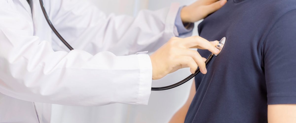 Doctor examination young man with stethoscope in hospital. healthcare and medicine
